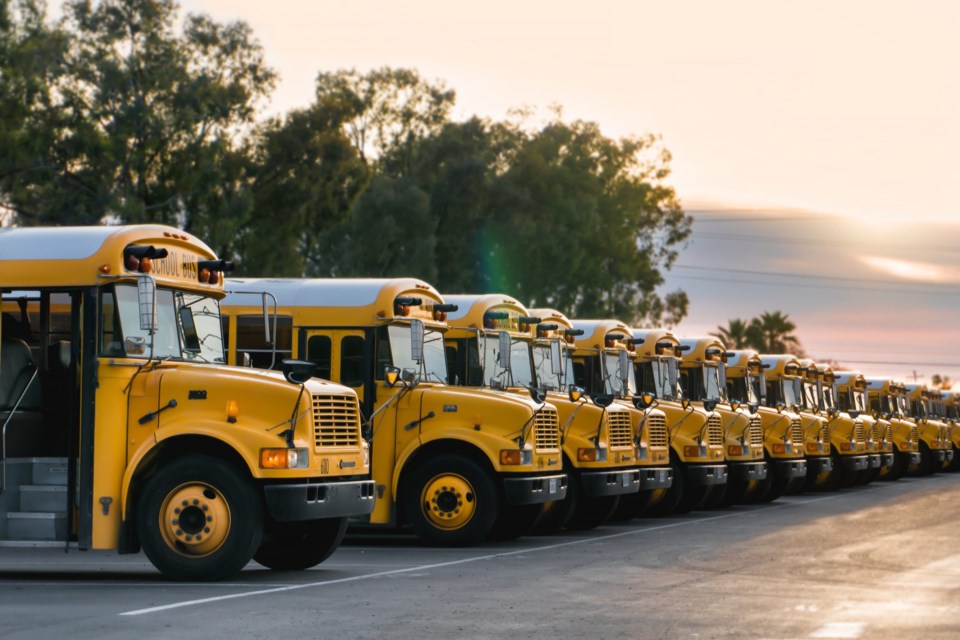 Row,Of,School,Buses,In,Parking,Lot