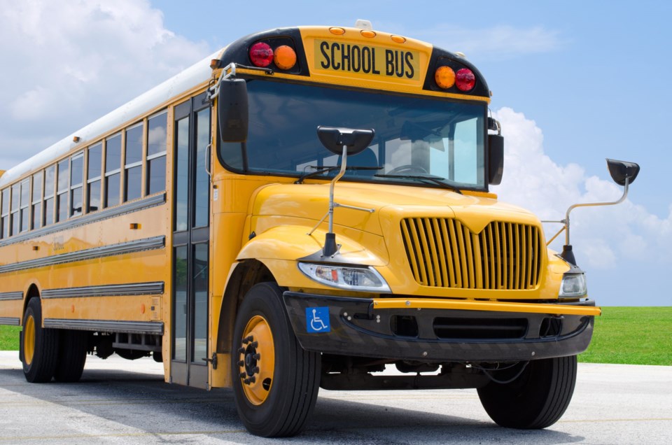School,Bus,On,Blacktop,With,Clean,Sunny,Background