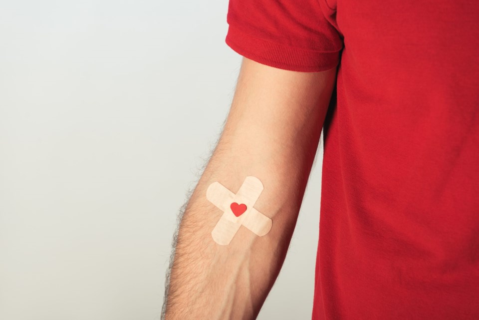 Partial,View,Of,Patient,In,Red,T-shirt,With,Plasters,On