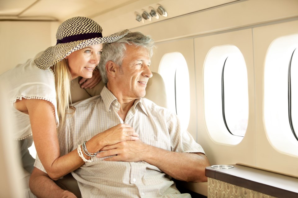 Taking,A,Luxury,Trip.,Smiling,Senior,Couple,On,An,Airplane