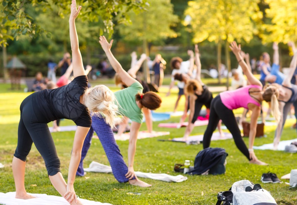 Big,Group,Of,Adults,Attending,A,Yoga,Class,Outside,In