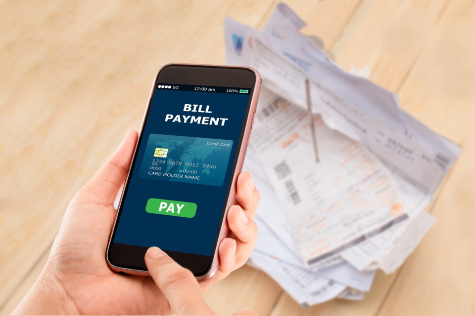 Online,Bill,Payment,Concept.hands,Holding,Mobile,Phone,On,Blurred,Electric