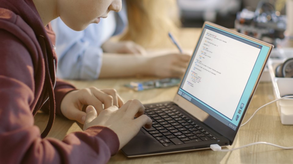 Smart,Young,Boy,Works,On,A,Laptop,For,His,New