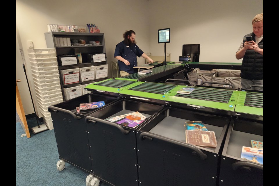 A staff member quickly sorts materials at the Longmont Library.