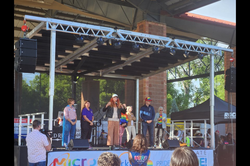 Colorado Rep. Brianna Titone speaks with other state representatives at a Longmont Pride rally on June 30, 2023.