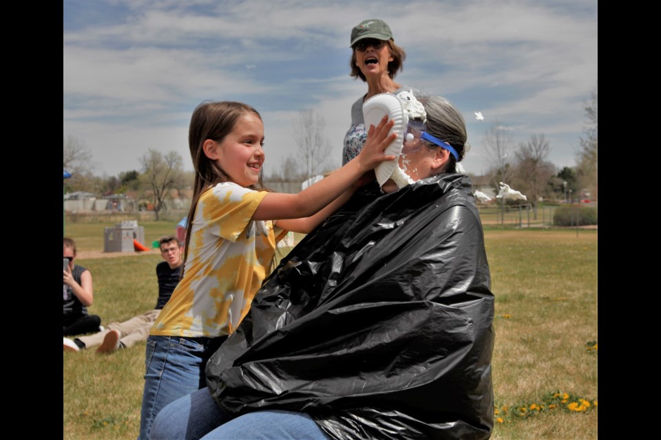 Longmont Christian School students celebrate their fundraiser success by pieing their teachers on Friday.