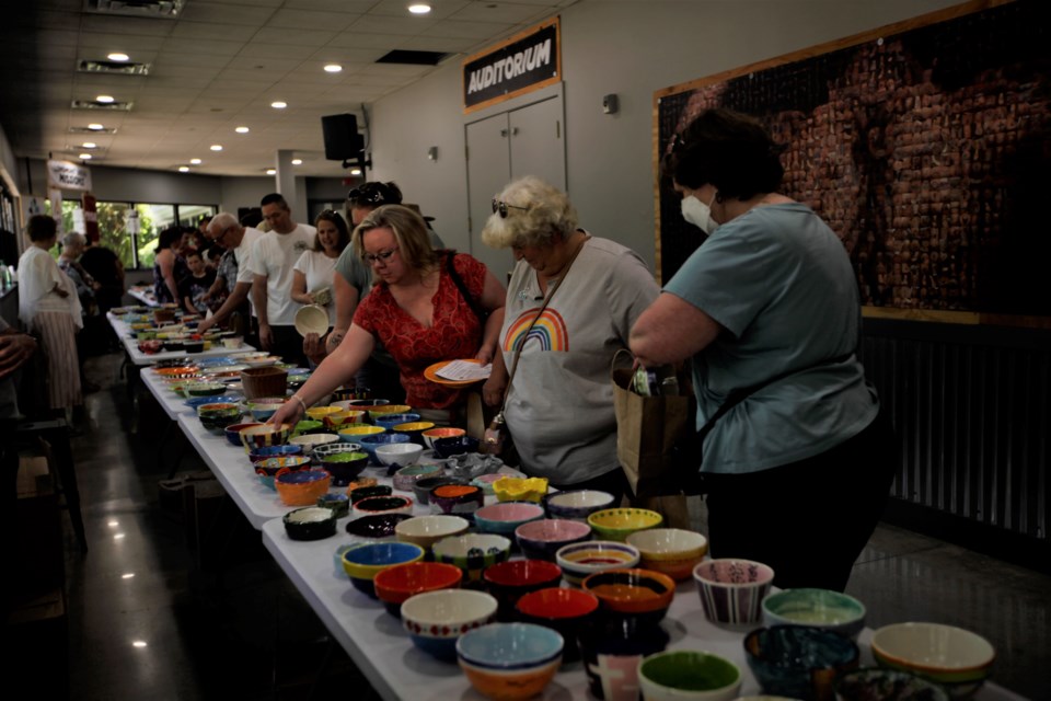 Attendees check out the bowls donated as part of the Empty Bowls fundraiser for OUR Center on Saturday at Flatirons Community Church.