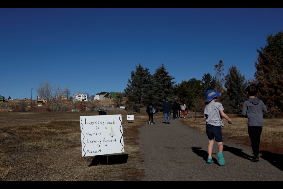 Louisville community members participate in the Walk to Heal to commemorate the upcoming one year anniversary since the Marshall Fire.