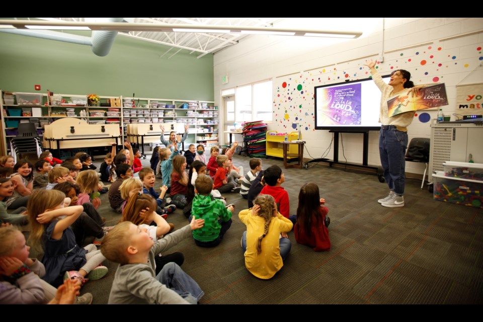 Cara Mentzel sings her children's book with kindergartners on Tuesday at Flagstaff Academy Charter School. Mentzel wrote the children's book with her sister and Broadway star, Idina Menzel.