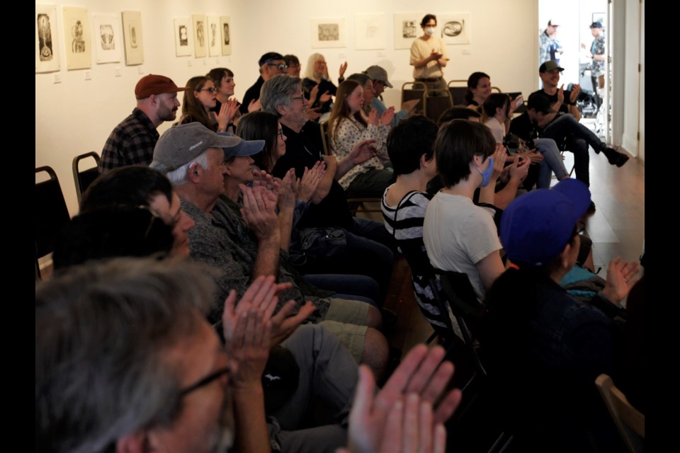 The audiences applauds for Mackenzie Rae at the Firehouse Art Center as part of Saturday's Winter Walkabout.