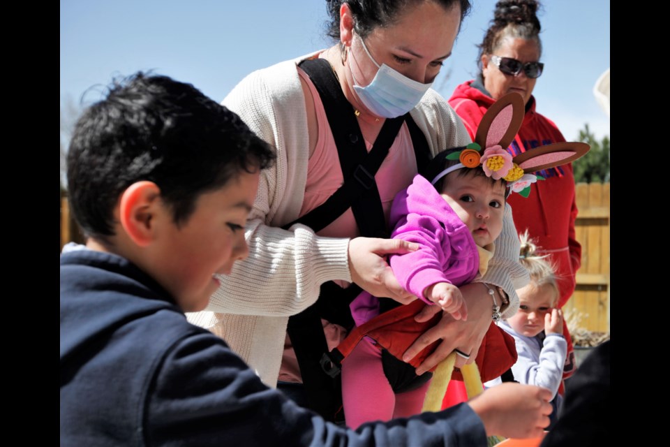 Children go on an Easter egg hunt on Friday at Life Care Center in Longmont.