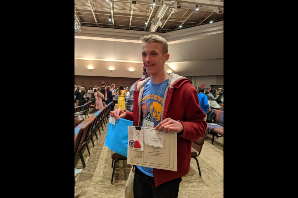 Eli Kraus poses with his awards at the Colorado Science and Engineering Fair earlier this month.