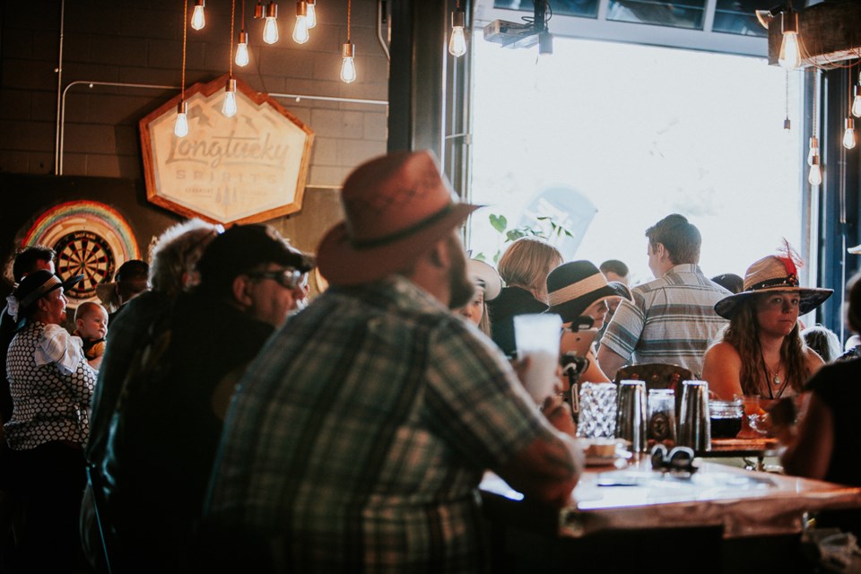 Patrons at a past Longtucky Derby party in Longmont's Abbott and Wallace Distilling | Photo by Lachlan Quintana 