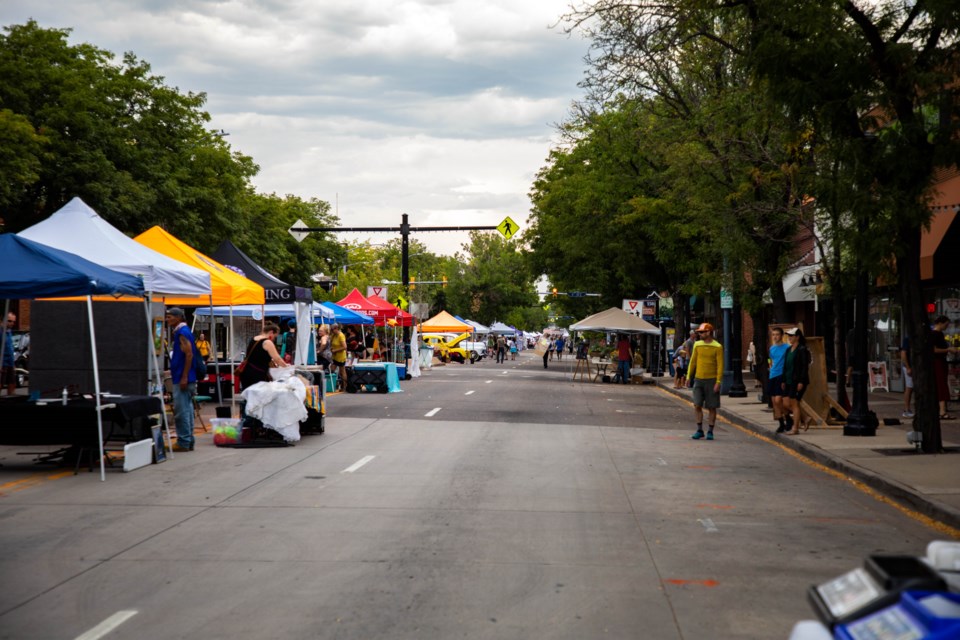 Though a few scattered drops graced the evening, the crowd gathered to celebrate ArtWalk and Longmont's 150th Anniversary.