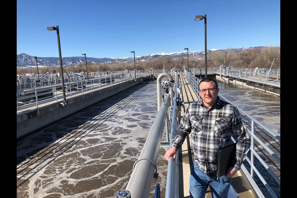 Cole Sigmon, the wastewater treatment manager for the City of Boulder's Water Resource Recovery Facility, stands near an aeration pond at the plant.

H20 Radio