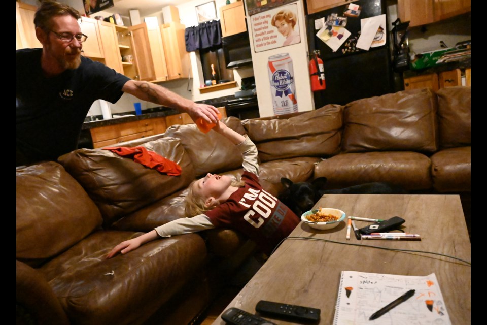 Six-year-old Trent Bickford, right, has grown up without his mom, Jackie, since she took her life when he was a baby. His dad, Travis Bickford, left, blames Mind Springs for his wife's suicide. (Photo by RJ Sangosti/The Denver Post)

COLab