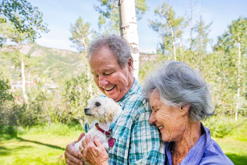 Betsy and Jim Chaffin hold their 10-month-old dog, Bella, in their home on Friday, July 23, 2021. Bella was lost in the Maroon Bells-Snowmass Wilderness for a month and was found after the community rallied together to help track her down. (Kelsey Brunner/The Aspen Times)

The Aspen Times
