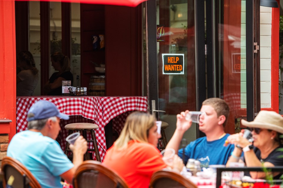 A “help wanted” sign hangs in the doorway of Aspen Pie Shop downtown as customers enjoy an afternoon meal on the patio in Aspen on Friday, July 16, 2021. (Kelsey Brunner/The Aspen Times)

The Aspen Times