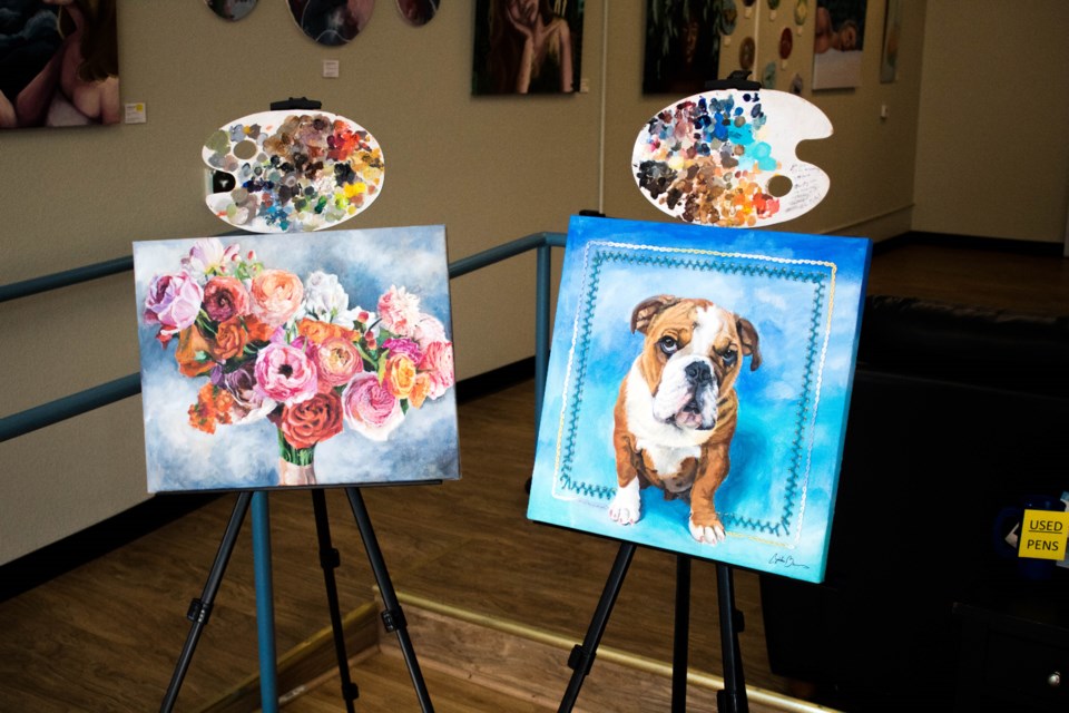 Cynthia Barnes paints pet portraits and wedding bouquets from LDDA window. (Photo by Matt Maenpaa)