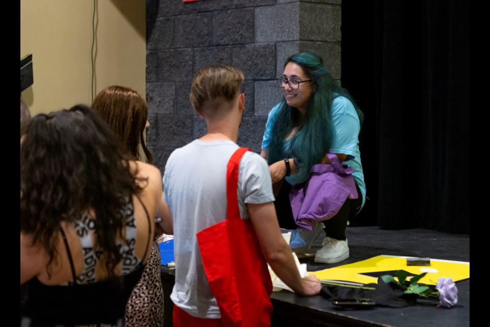 Alex Colin(right) converses with her fellow castmates during a rehearsal for the Arts HUB Players' production of Disney's Descendants on Aug. 8. Photo by Ali Mai