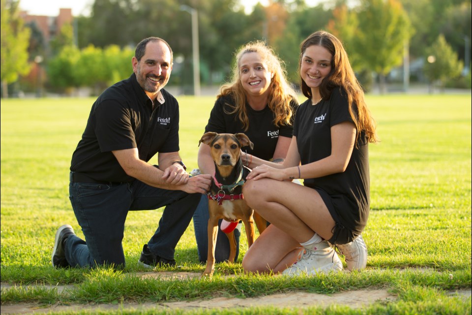 Fetch! Pet Care Loveland to Boulder owner staff left to right: owner Patrick Kuhnell, pet sitter Caryn Malone and pet sitter Nicole Marucci pet Malone's dog at Roosevelt Park on Sept. 24. Photo by Ali Mai