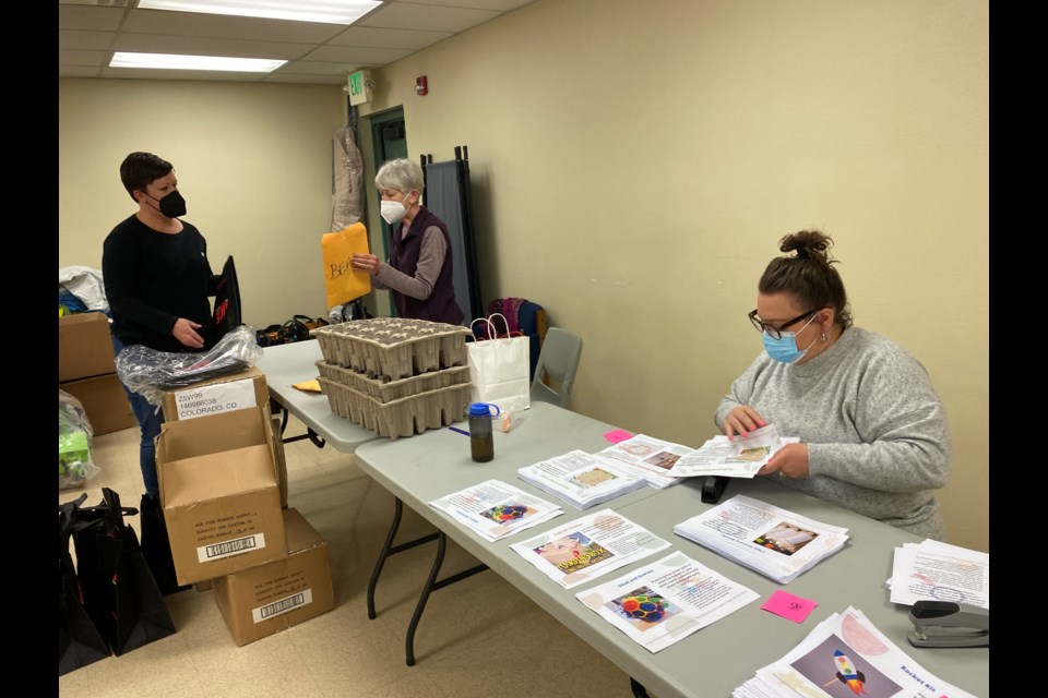 Angela Jenson prepares Nature Walk guide for the preschoolers' toolkits. 