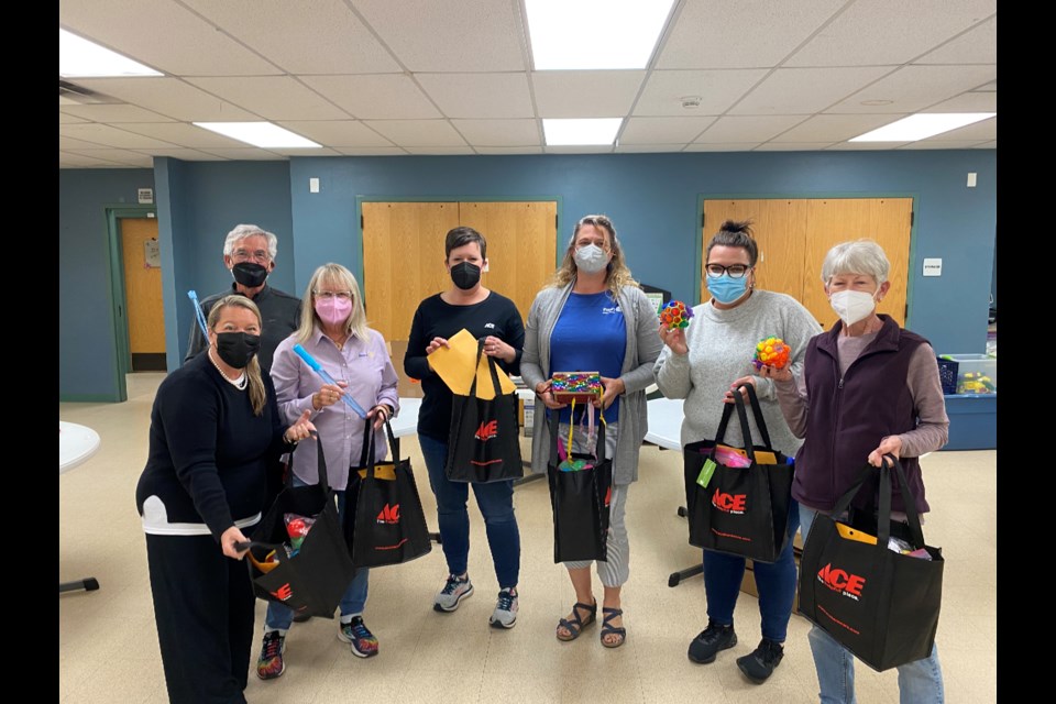 The members of the Rotary Club of Longmont Twin Peaks and Wild Plum who helped assemble the toolkits, which will be handed out at the start of next week. 