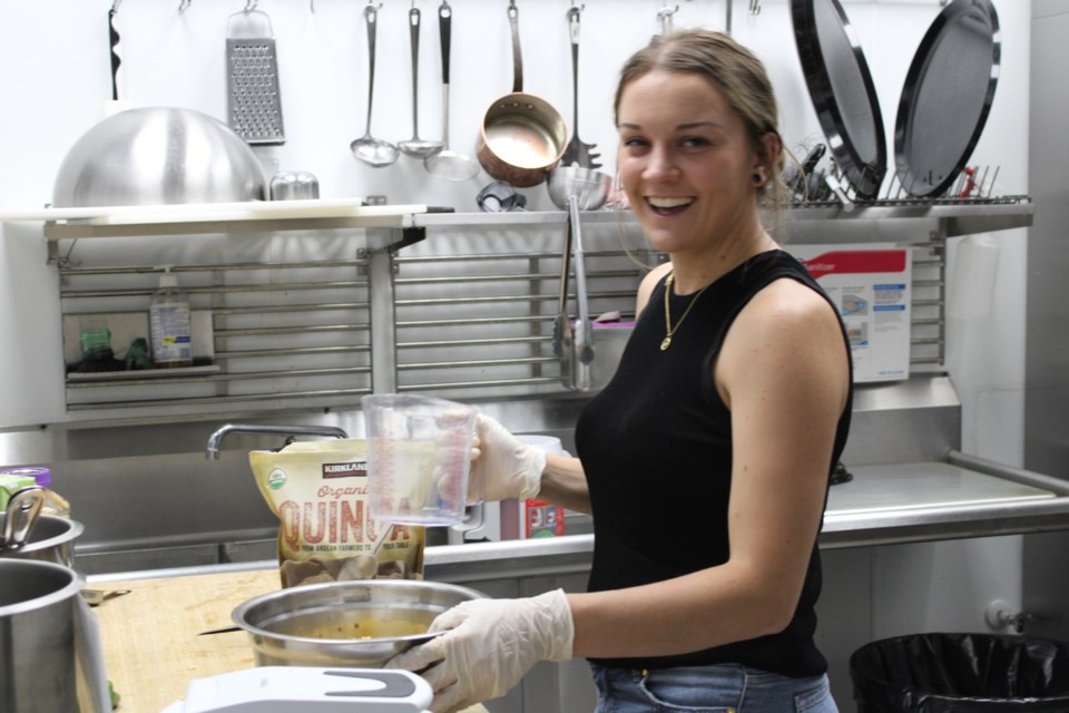 Lauren Tregoning prepares her vegan menu for the Boulder County Farmers Market
