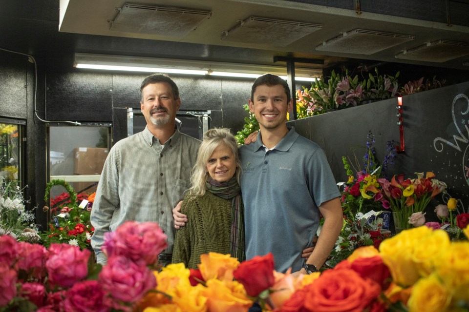 Owners of Longmont Florist Brad and Lisa Golter and their son and manager of the flower shop Nate Golter stand inside of the plant cooler on Dec. 7. Photos by Ali Mai