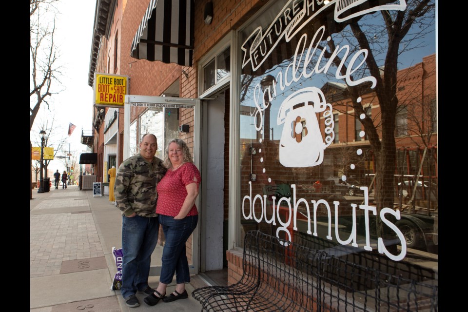 Landline Doughnuts & Coffee owners John and Jodi ââMowery at their downtown Longmont storefront thatâs opening May 2022. Photo by Ali Mai 