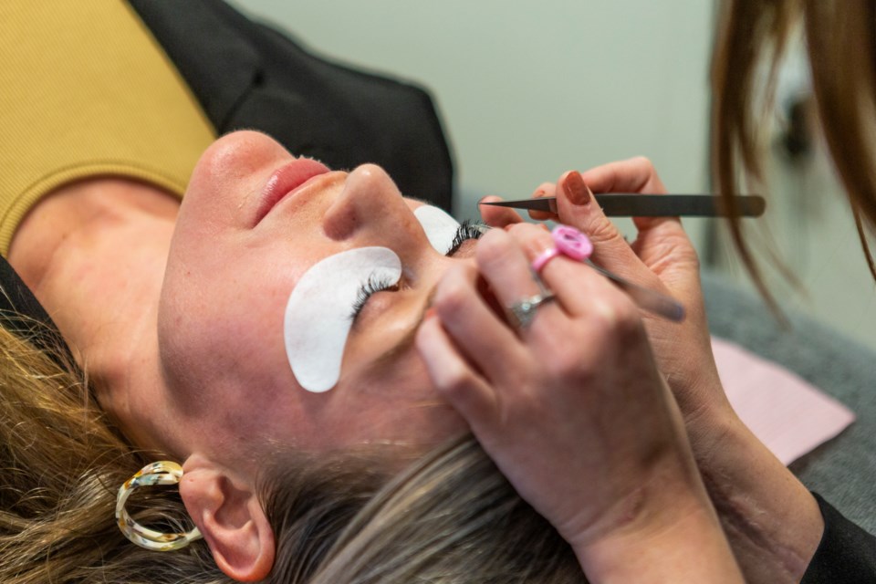 Lash + Company Longmont esthetician Shay Holton demonstrates how to apply lash extensions on the med spa owner Serena Jacob. Photos by Ali Mai 