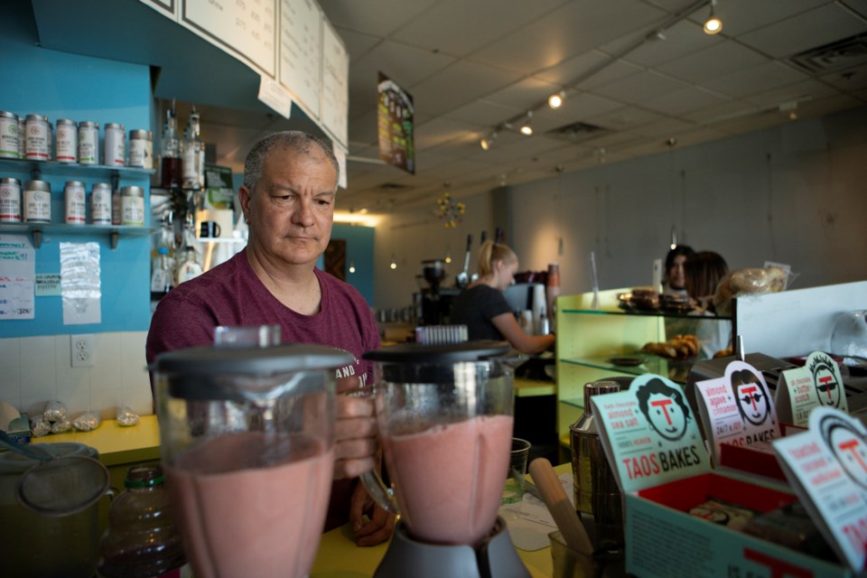 Rob Quesenberry, owner of Queâs Espresso in Longmont, makes smoothies on March 31. Photo by Ali Mai 