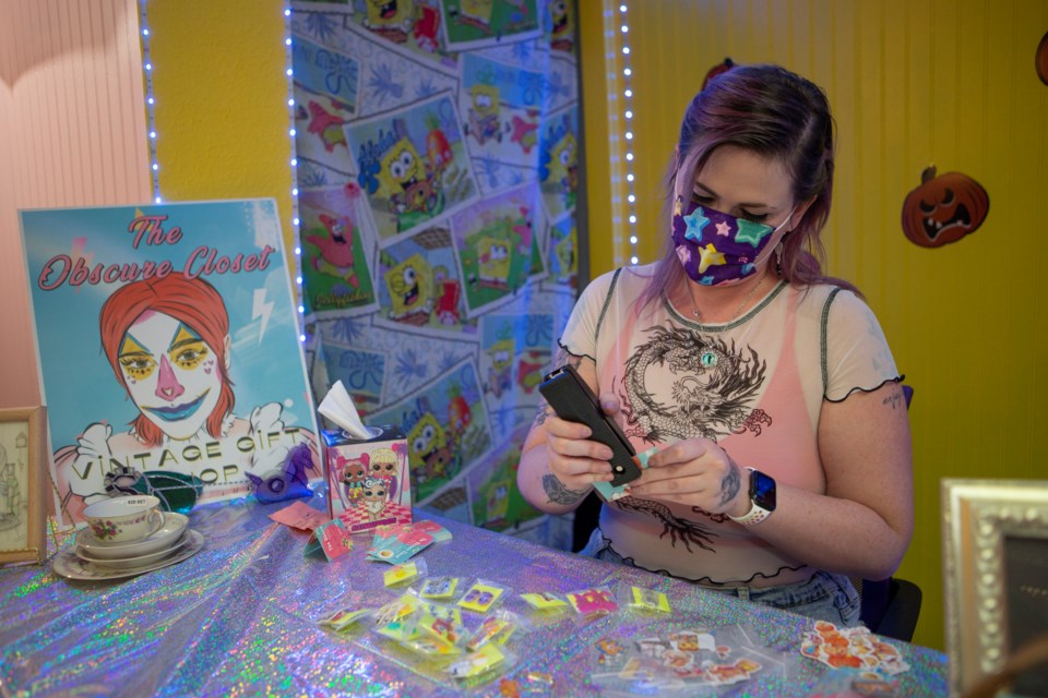 The Obscure Closet owner Elise Blackford works on sticker packs at the Longmont store inside of The Old Town Marketplace. Photo by Ali Mai