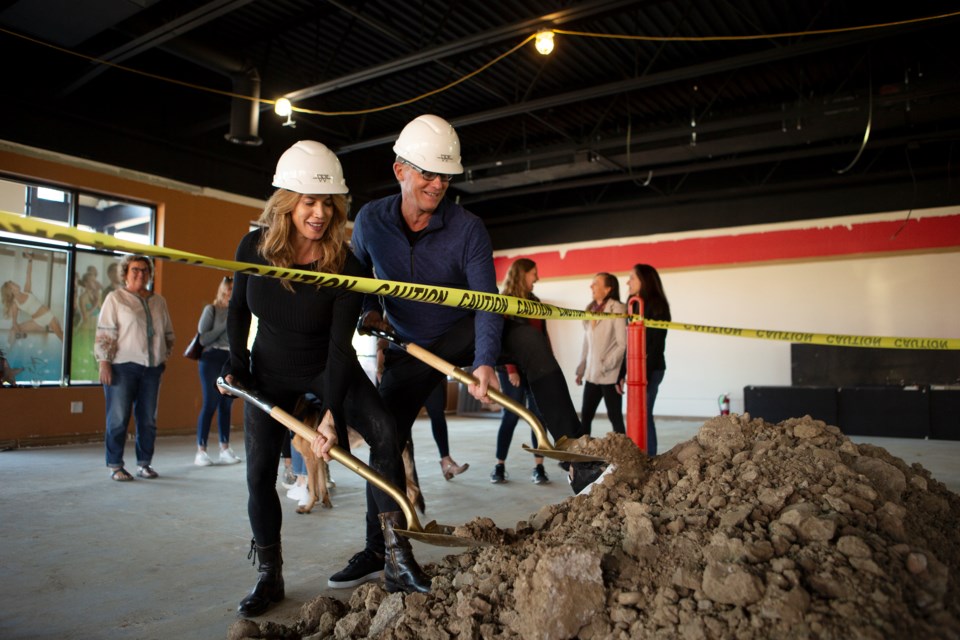 Nicole and Gerry Wienholt, founders of Yoga Pod Inc., break ground on the new Longmont Yoga Pod Studio on Oct. 15. Though there are Yoga Pod franchises in five states, the Longmont studio will be the second one owned and operated by the Wienholts including Boulder Yoga Pod. Photo by Ali Mai