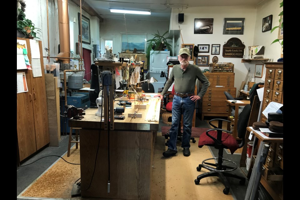 Michael Clark poses in his workshop