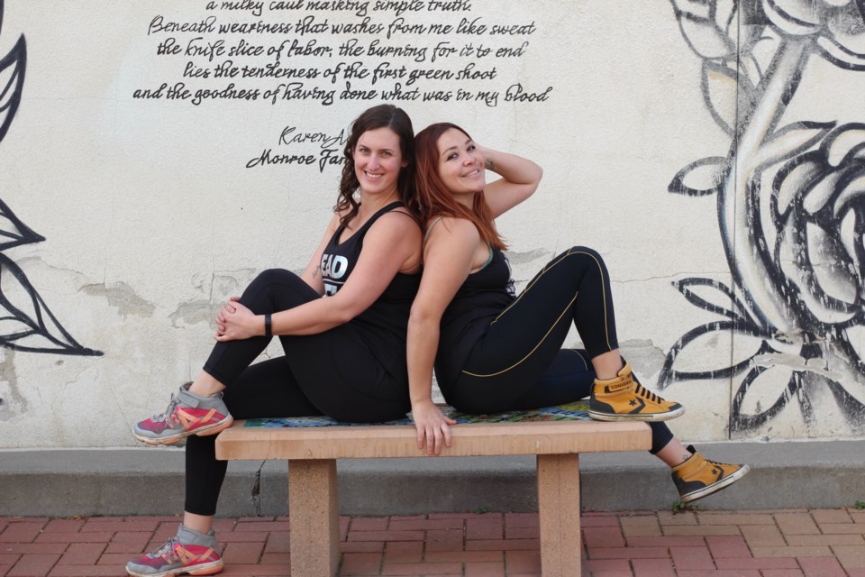 Katie Winter (left) and LIliana Resendiz (right) owners of Ignition Dance Fitness pose in Downtown Longmont breezeway