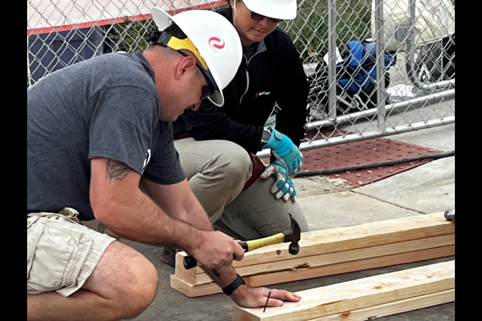 Xcel Energy volunteers on Day of Service to help Veterans Community Project build frame for tiny homes that will soon house area veterans.