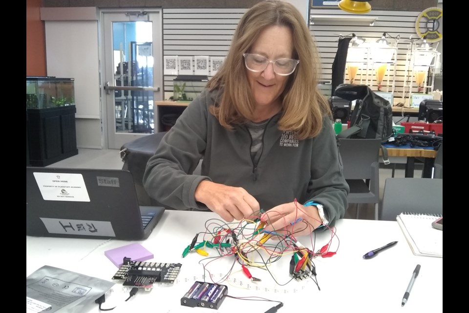 Terri Reh, middle school science/robotics teacher at Flagstaff Academy, works on a data sensor hub (DaSH) board for her classroom. 