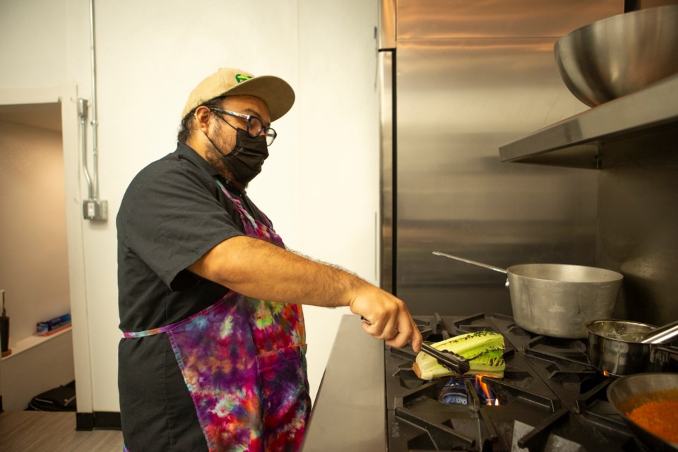 Shine Provisions owner and chef Zachary Shine cooks romaine lettuce for his chard caesar salad at the Times Collaborative on Sept. 30. The salad is the first item on the three course menu for Longmont Restaurant Week followed by a bolognese and devils food cake. Photo by Ali Mai