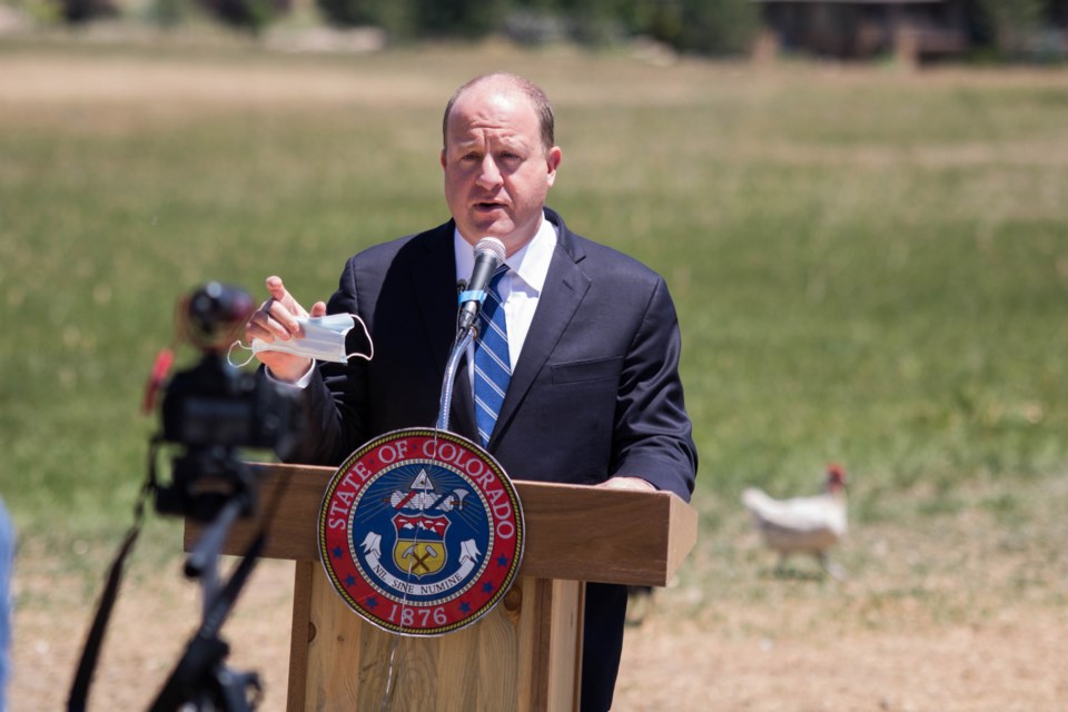 Gov. Jared Polis addresses the crowd gathered at Bluebird Sky Farmstead in Longmont on Wednesday for a signing ceremony of House Bill 1343. The bill requires that eggs from Colorado-raised chickens will be cage-free by Dec. 31, 2024.
(Photo by Matt Maenpaa)