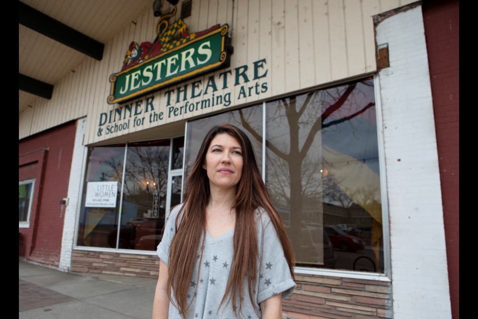 Amber Sutherland stands outside of the family-owned Jesters Dinner Theatre in downtown Longmont on March 16. Sutherland, a performer at Jesters, is leading a "Save the Jesters" GoFundMe fundraiser to raise $2 million by Apr. 4, 2022, when the 23-year-old business goes up for sale. After a long run, Jesters owners are ready to close this chapter in their lives. But Sutherland, along with other Jesters performers, employees and customers aren't ready to see it go. Photo by Ali Mai | Longmont Leader