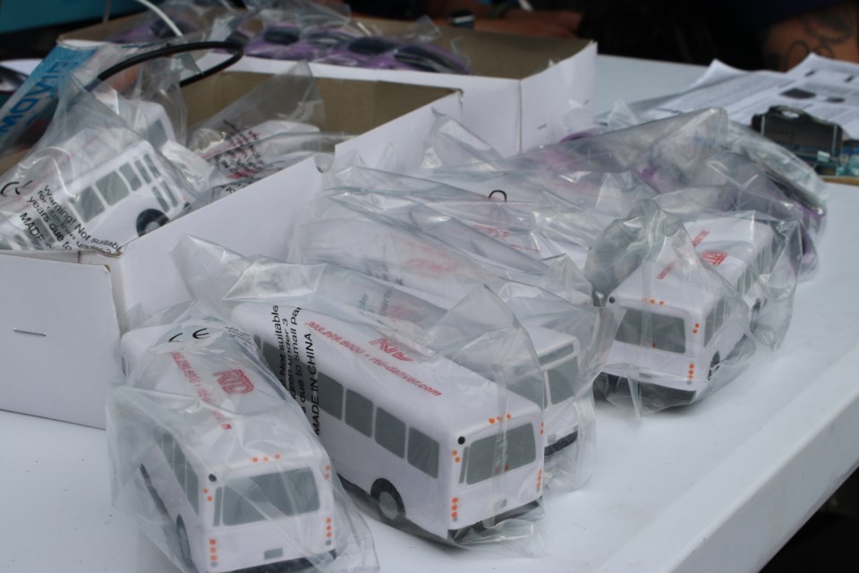 Squeeze-toy buses provided by the Denver transit authority were just one of the incentives provided to encourage people to get vaccinated at a mobile clinic arranged by public health and transit officials June 23 in Aurora, Colorado. (Markian Hawryluk/KHN)