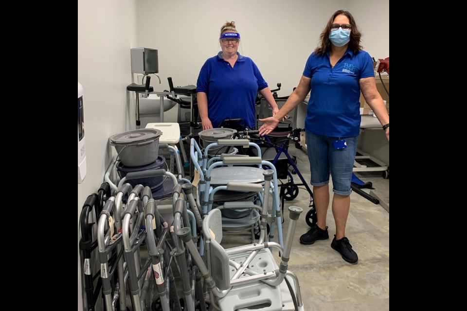 At the Foundation for Rehabilitation Equipment and Endowment in Richmond, Virginia, Liz Dennis, left, equipment technician, and Lisa Soto, program coordinator, stock and organize the equipment closet with refurbished inventory. Volunteers and staffers at FREE received 10,000 pieces of donated equipment last year and refurbished 6,500 to put back into use. (Robin Ramsey)