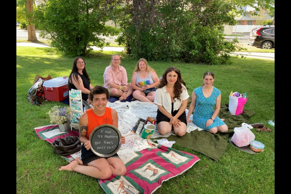 Dani Marietti (holding sign) and her friends gather for a âsterilization showerâ in Helena, Montana, in July before Marietti was scheduled to have her fallopian tubes surgically removed. (Ellis Juhlin/Yellowstone Public Radio)