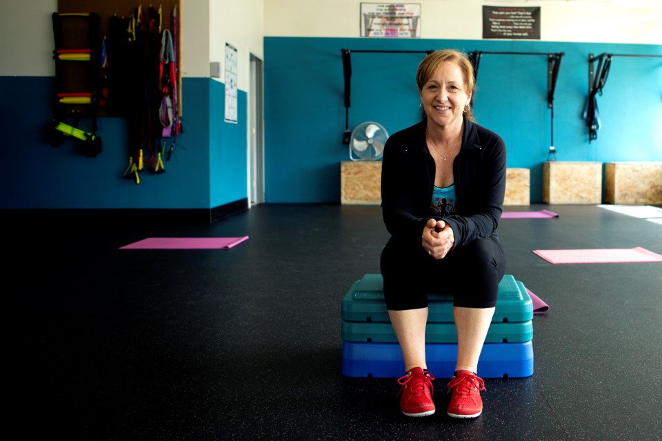 Angie Marone, owner of Fit Chick Express, sits in the Longmont studio on March 9, 2021. Marone describes the women's fitness studio as an experience and community. 