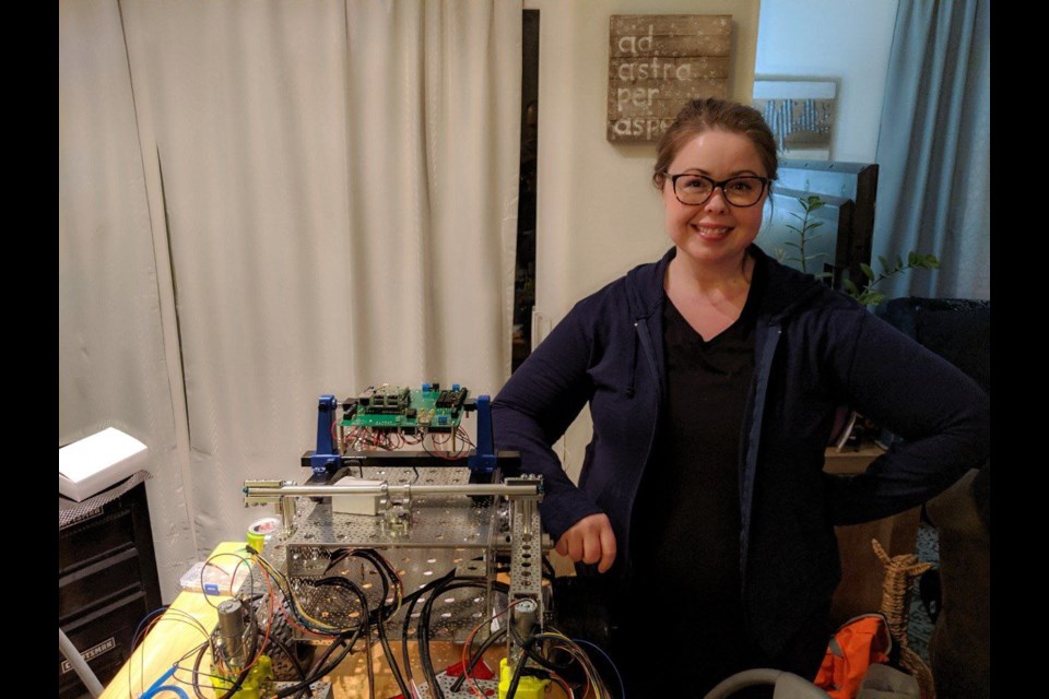 Valerie Eastman, CEO and founder of WinterWinds Robotics stands with a prototype. 