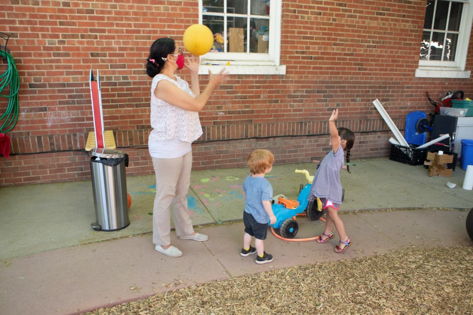 Celeste Ortega plays catch with children at the Aspen Center for Childhood development on the preschoolâs playgrond on June 15. Photo by Ali Mai | ali.mai.journo@gmail.com