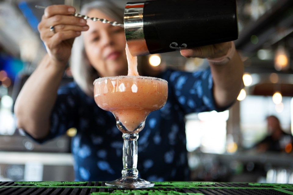 CYCLHOPS Bike CANtina owner Anita Gray makes a Strawberry Margarita on Aug. 4. The restaurant has a strong emphasis on tequila drinks and carries about 35 different varieties of the liquor. Photo by Ali Mai | ali.mai.journo@gmail.com