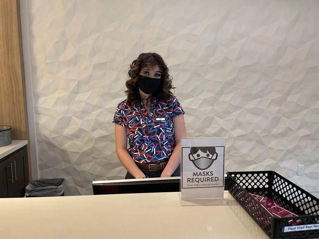 Liz Guillemont attends the front desk waiting to welcome hotel guests