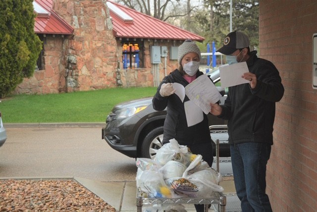 Longmont Meals on Wheels volunteers coordinate delivery. 
(Photo by Katie Wiser, Longmont) Meals on Wheels